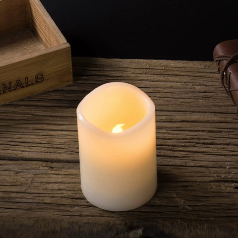 12 Pack Flameless Candles With Real Wax Battery Operated LED Pillar Candles Unscented Ivory Color Including Remote Control And 24 Hour Timer Diameter 3 Inches Height 4 Inches Perfect For Cozy Home Vibes Parties Weddings And Events on wooden table