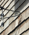 Stainless Lag Eyebolt Set One Half Inch By Six Inch T316 Marine Grade installed on a wooden exterior wall with light fixtures