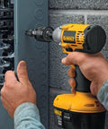 Hand using DeWalt impact driver with Impact Driver Drill Chuck With One Quarter Inch Quick Connect on grey panel