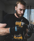 Person wearing Never Slip All Purpose Work Gloves With Maximum Grip Nylon Construction And Patented Coating working with drill