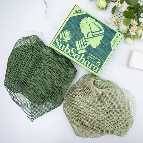 Authentic African Net Sponge 2 Pack Exfoliating Bath And Shower Loofah Sponge For Body And Face Go To Scrub For All Skin Types Travel Durable Polyester Olive Green And Light Green with packaging and flowers.