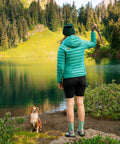 Person by lake wearing jacket with Tenacious Tape Repair Patches Peel And Stick Nylon Gear Patches for Jackets Tents Sleeping Bags.
