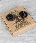 Spiral Fake Gauge Earrings Set In Black With Organic Wood And 316L Surgical Steel, unisex faux plugs on Earth Accessories box.