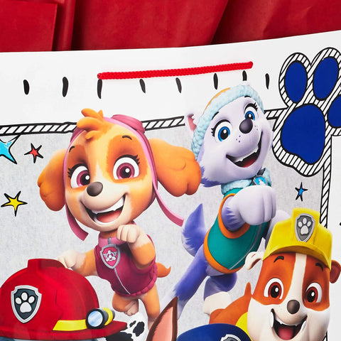Close-up of Totally Extra Large Paw Patrol Gift Bag with Chase, Everest, Skye for birthdays and parties, 15 inch white bag with tissues.
