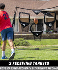 Man practicing with Six By Six Foot Football Throwing Net For QB Training And Passing Accuracy With Three Target Pockets Simulating Prime Receiving Areas.