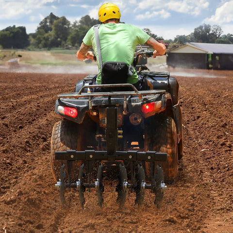 Man using 28 Inch Tractor Disc Plow Harrow With 2 Inch Receiver For ATV Pull Behind Tiller Adjustable Height 13.7 To 21.1 Inches