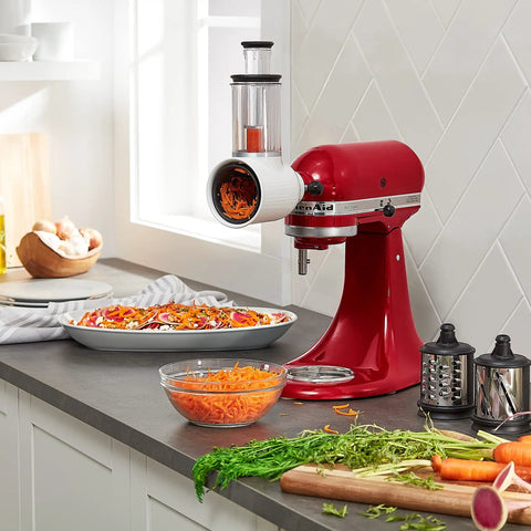 Fresh Prep Slicer Shredder Stand Mixer Attachment in use, slicing carrots with three blades, fits most mixers, durable stainless steel
