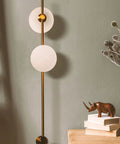 Equinox LED Wall Sconce Indoor Plug In Light For Bedroom And Bathroom With Glass Globe Shades Industrial Wall Mounted Fixture And On Off Switch Gold Finish Perfect For A Modern Home Vibe, showing gold sconce with frosted globes on green wall