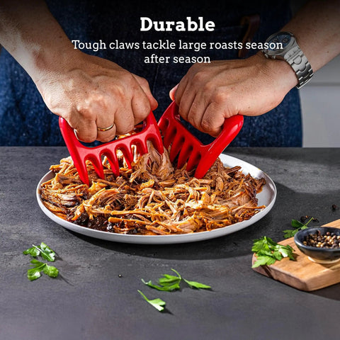 Bear Claw Meat Shredders 2 Pack Heat Resistant And Durable in use for pulling pork on a plate with ergonomic red handles.
