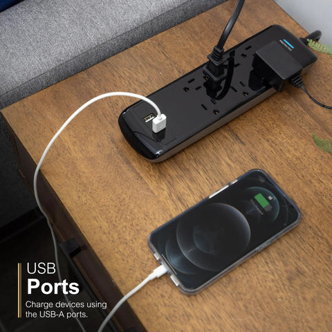 7-Outlet Surge Protector With 2 USB Ports, 3 Ft Flat-Plug Extension Cord, black, on desk charging phone via USB port