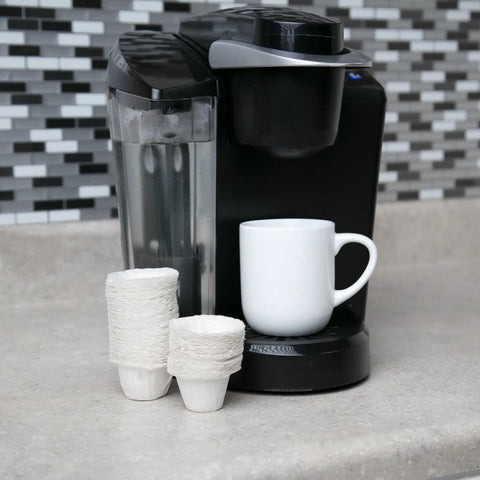 Disposable Paper Coffee Filters 300 Count Compatible With Keurig And K Cup Machines next to coffee maker