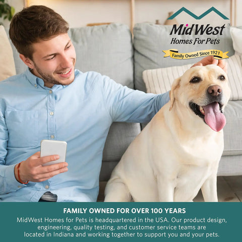 Man happily sitting on a couch with a Labrador retriever, showcasing dog-friendly home environment.