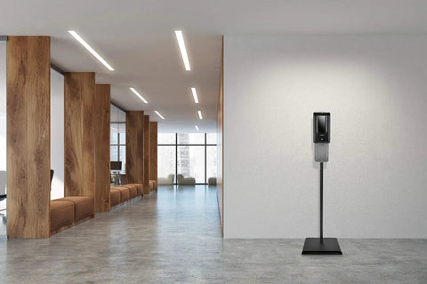 Solid Touchless Hand Sanitizer Dispenser On Heavy Duty Steel Floor Stand With Catch Tray And Refillable Bottle in modern office setting.