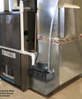 Automatic Condensate Pump With Safety Switch For HVAC And Dehumidifier installed next to furnace, visible tubing and tank