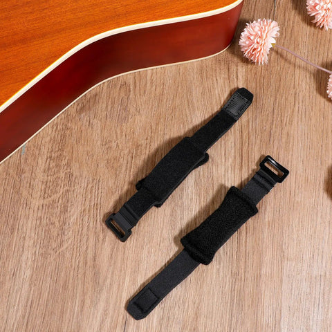 2 Pack Guitar String Dampener Set With Fret Mutes And Bass Muffler Silencer Damper, Adjustable Straps on wooden surface