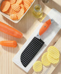 VITUER crinkle cutter with orange handle and black wave blade on cutting board; carrot and potato chips nearby.