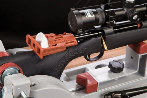 Close-up of Rapid Deluxe Bore Guide Kit with four muzzle guides on a rifle for precise cleaning rod alignment.
