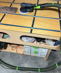 Eight Pack Coiled Hose Clips For 36mm Dust Collection Hoses installed on vacuum hose in a workshop, preventing trip hazards.