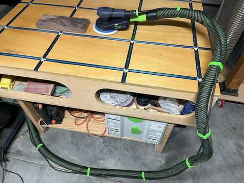 Eight Pack Coiled Hose Clips For 36mm Dust Collection Hoses installed on vacuum hose in a workshop, preventing trip hazards.