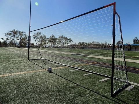 24 X 8 Foot Regulation Soccer Goal With Weatherproof Net And Heavy Duty Powder Coated Galvanized Steel Frame 50mm Tubing Portable Training Aid For Backyard Practice One Year Warranty on a field