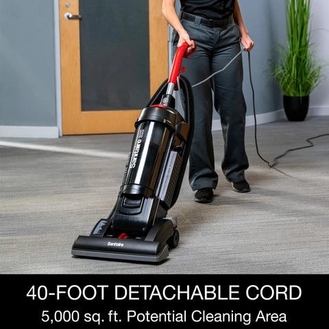 Heavy Duty Commercial Upright Vacuum Cleaner Featuring A Massive 15 Inch Wide Cleaning Path That Legit Crushes Carpet Dirt And Ground In Grime CRI Certified Beast Mode For Pro Cleaners. User operating vacuum with a long cord.