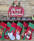 Top Shelf Cast Iron 3D Train Christmas Stocking Holder With Santa Sleigh And Four Rail Carts Six Stocking Hooks displayed on a mantel with stockings.