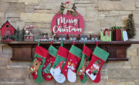 Top Shelf Cast Iron 3D Train Christmas Stocking Holder With Santa Sleigh And Four Rail Carts Six Stocking Hooks displayed on a mantel with stockings.