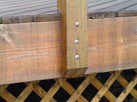Top Shelf Construction Lag Screws 5 16 By 3 Inch Bronze Hex Fasteners 30 Pack holding wooden beams in a deck structure.