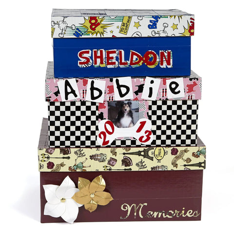 Stack of personalized and decorated memory boxes with patterned designs and names