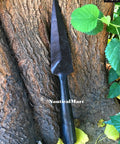 Hand Forged Viking Saga Iron Spear Point For Reenactment And LARP Carbon Steel Long Spearhead against a tree trunk.