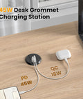 Sleek 2 Inch Desk Power Grommet Outlet With AC Receptacle And Multiple USB Ports delivering quick charging on a wooden desk.
