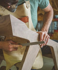 Pro Grade Six Inch Warding Hand Rasp Featuring Soft Touch Grip Handle being used on wood for fine shaping in a workshop.