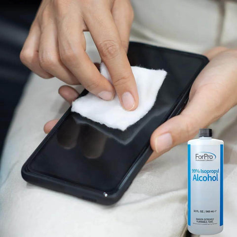 Person cleaning smartphone with cotton pad beside ForPro 99 Percent Isopropyl Alcohol For Surface Cleaning Unscented 32 Fl Oz USA Made Methanol Free bottle