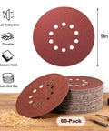 9 Inch Hook And Loop Drywall Discs Set 60 Pieces 10 Holes 40 To 240 Grits, stacked on a wooden table with tools.