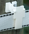 Wood Post Insulator For Poly Tape Electric Fence 250 Pack No Brainer Quick Install With Locking Tape Holder Extends Tape Two Inches From Post Includes Nails Heavy Duty Poly Construction on wooden post with white tape