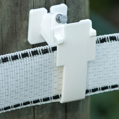 Wood Post Insulator For Poly Tape Electric Fence 250 Pack No Brainer Quick Install With Locking Tape Holder Extends Tape Two Inches From Post Includes Nails Heavy Duty Poly Construction on wooden post with white tape