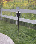 Conical Bronze Outdoor Torch Set For Backyards And Patios, Weather Resistant And Citronella Oil Compatible, installed in backyard