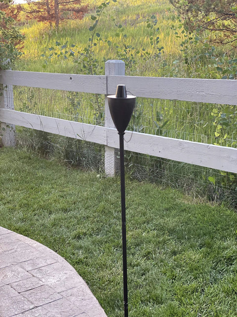 Conical Bronze Outdoor Torch Set For Backyards And Patios, Weather Resistant And Citronella Oil Compatible, installed in backyard
