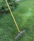 All Purpose Garden Landscape Rake With 21 Inch Head And 47 Inch Lightweight Wood Handle on grass