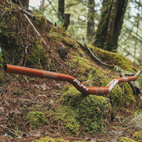 Upturn High Rise Mountain Bike Handlebar With 31.8mm Clamp, 785mm Width, Lightweight Alloy Riser Bar for MTB, shown on forest ground