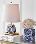 Blue White Ceramic Owl Table Lamp With Linen Shade on nightstand with books and vase