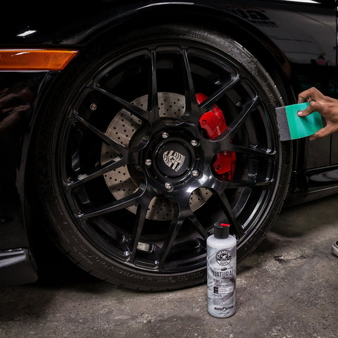Applying tire dressing with Wonder Wave Durafoam Tire Shine Applicator Pads With Contour Wave Design on a large SUV tire