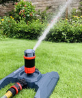 Four Pattern Adjustable Rotary Sprinkler With Quick Connect Starter Set For Lawn And Garden, 360 Degree Coverage in operation on grass