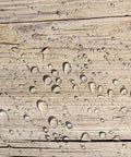 Water droplets on wood surface showcasing Heavy Hitter Water Repellent Concrete Sealer Boasting A Natural Matte Finish Water Based Low Voc Formula For Driveways And Patios Drops Ultimate Storm Shield Protection Without Gunky Shiny Buildup Inside A Chunky Five Gallon Container.