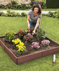 Woman gardening in All Weather Raised Garden Bed Kit With 8 Adjustable Panels For Easy Backyard Planting, Durable Polypropylene Planter Box