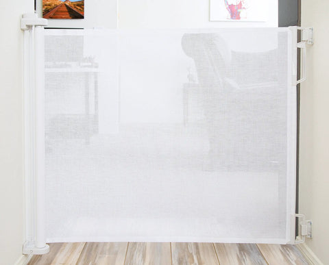 Retractable Indoor Outdoor Pet Safety Gate For Doorways And Stairs Up To 54 Inches mounted between walls with floor view