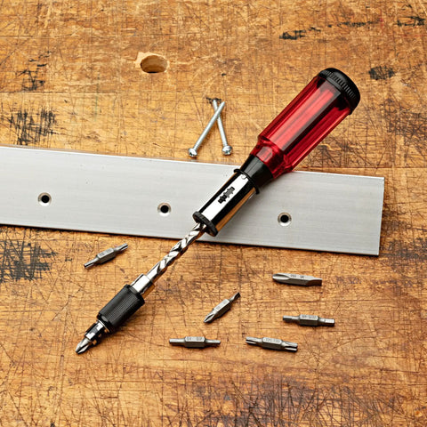 9.75 Inch Yankee Screwdriver Hand Drill Pin Vise With 7 Double Sided Bits on a wooden workbench, red handle, metal components.