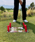 Golfer using Speed Trap Two Point Zero Golf Swing Trainer on green field with polycarbonate base and red rods visible