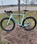 Blue road bike with G27 700C Carbon Gravel Wheelset, 50mm aero rims, in a park setting.