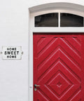 Built Like A Tank Cast Iron Home Sweet Home Wall Decor Featuring Distressed Antique White Finish on red door.